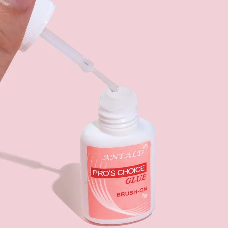 A white bottle of Antald Pro's Choice Glue brush-on nail glue with a white applicator tip.