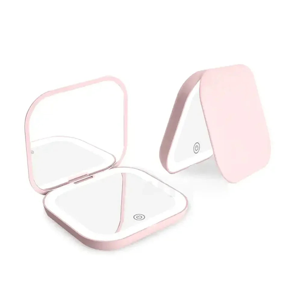 Miroir de vanité pliable rose avec lumière LED intégrée, ouvert et partiellement fermé.