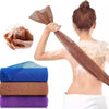 A woman is using a exfoliating mesh body scrubbing towel to scrub her skin, with various colored exfoliating pads visible.