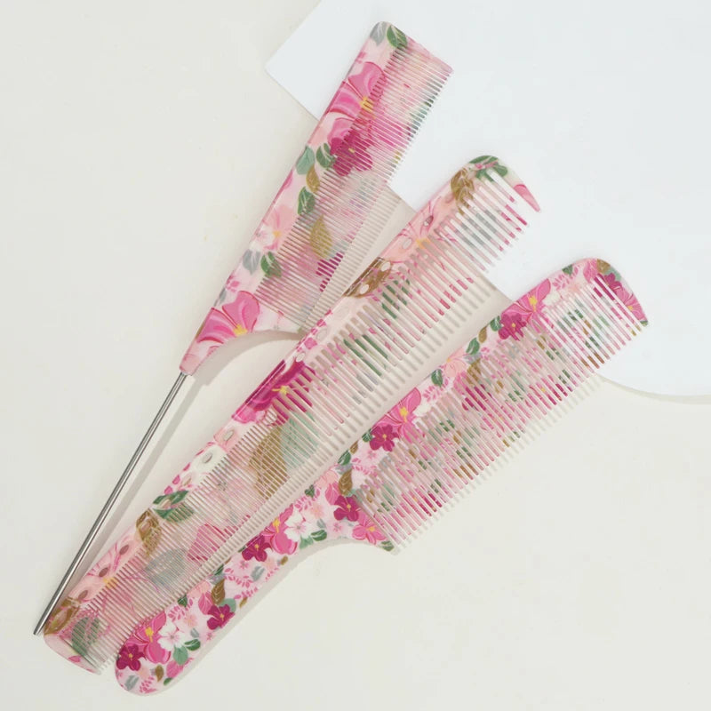 A pink floral hair comb set with fine teeth is displayed on a white background.
