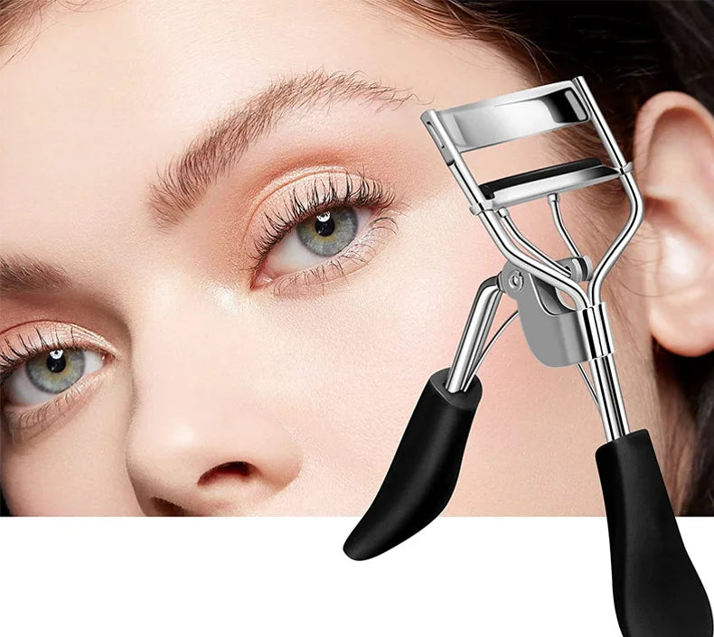 A close-up of a silver eyelash curler tool being used on a woman's eye.