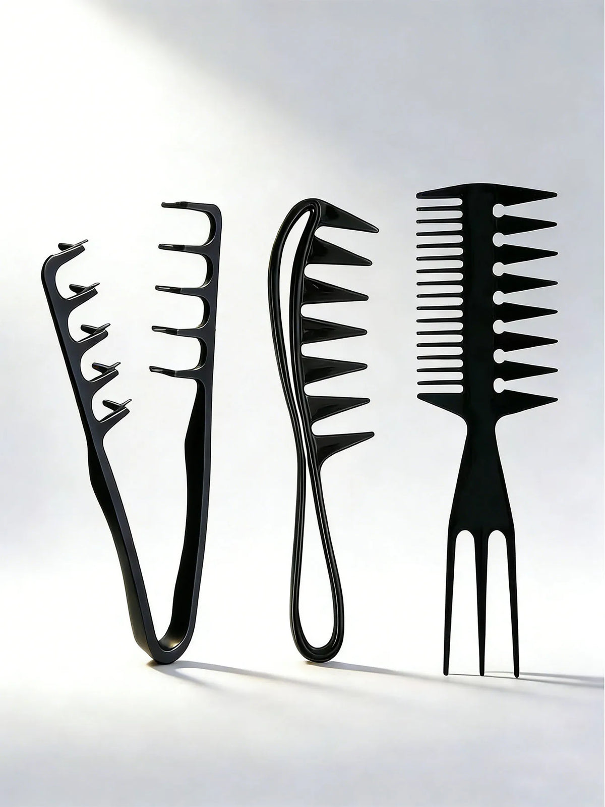 A set of black men's salon hair styling combs displayed against a bright, minimalist background.