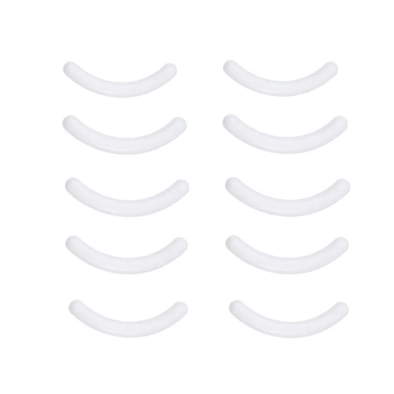 A set of stainless steel eyelash curler clips arranged in a row.