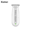 A white Kemei baby clipper with a metal comb attachment.