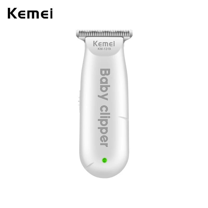A white Kemei baby clipper with a metal comb attachment.