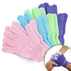 A hand shows a variety of colorful exfoliating bath gloves stacked together.