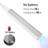 A white portable UV LED nail dryer device shown with instructions for battery operation.