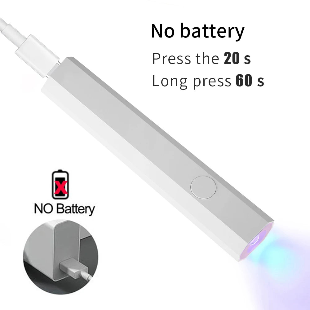 A white portable UV LED nail dryer device shown with instructions for battery operation.