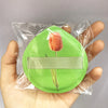 A green makeup puff with a dried orange rose on a white band is sealed in a clear plastic storage bag.