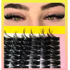 Close-up of natural-looking black faux mink individual lash clusters being applied to an eye.