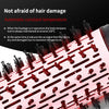 A close-up view of a pink hot air brush with black bristles, demonstrating its use for hair styling.
