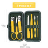 A set of seven stainless steel beauty tools, including scissors, nippers, and files, stored in a dark green travel case.