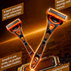 Orange precision safety razor with six blades shown against a dark background