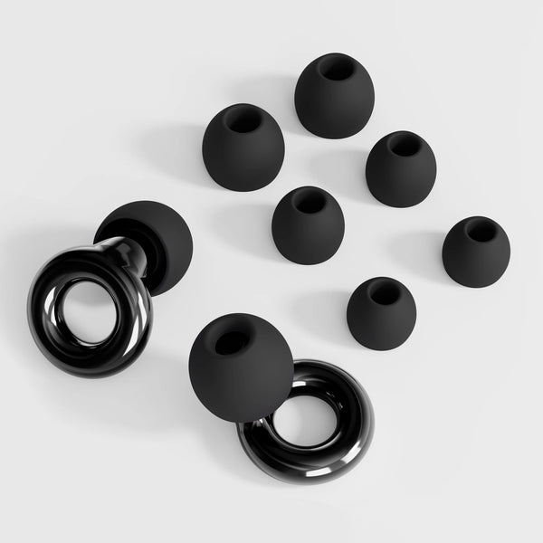 A collection of black reusable earplugs scattered on a white surface.