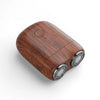 A close-up view of a wooden mini electric beard trimmer shaver with silver rotating heads.