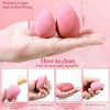 A hand holds a pink silicone makeup sponge, demonstrating how to clean and reuse the product.