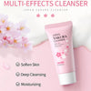 A pink tube of Japan Sakura Cleanser facial wash with a white cap, set against a soft pink background and cherry blossoms.