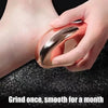A hand is holding a rose gold glass foot file tool, demonstrating its use for smoothing skin.