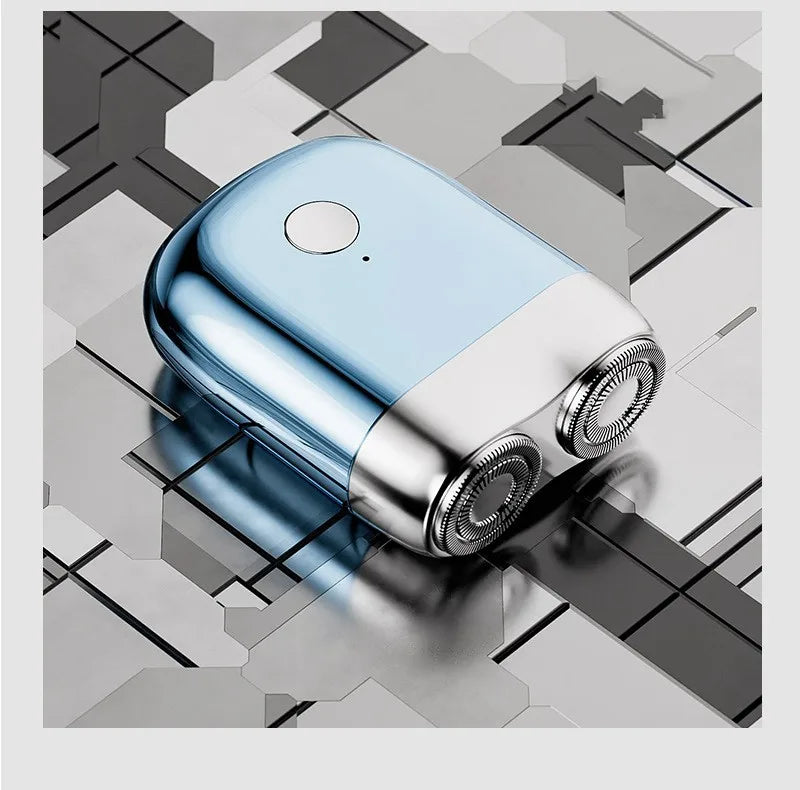 A light blue and silver mini electric beard trimmer shaver resting on a geometric gray surface.