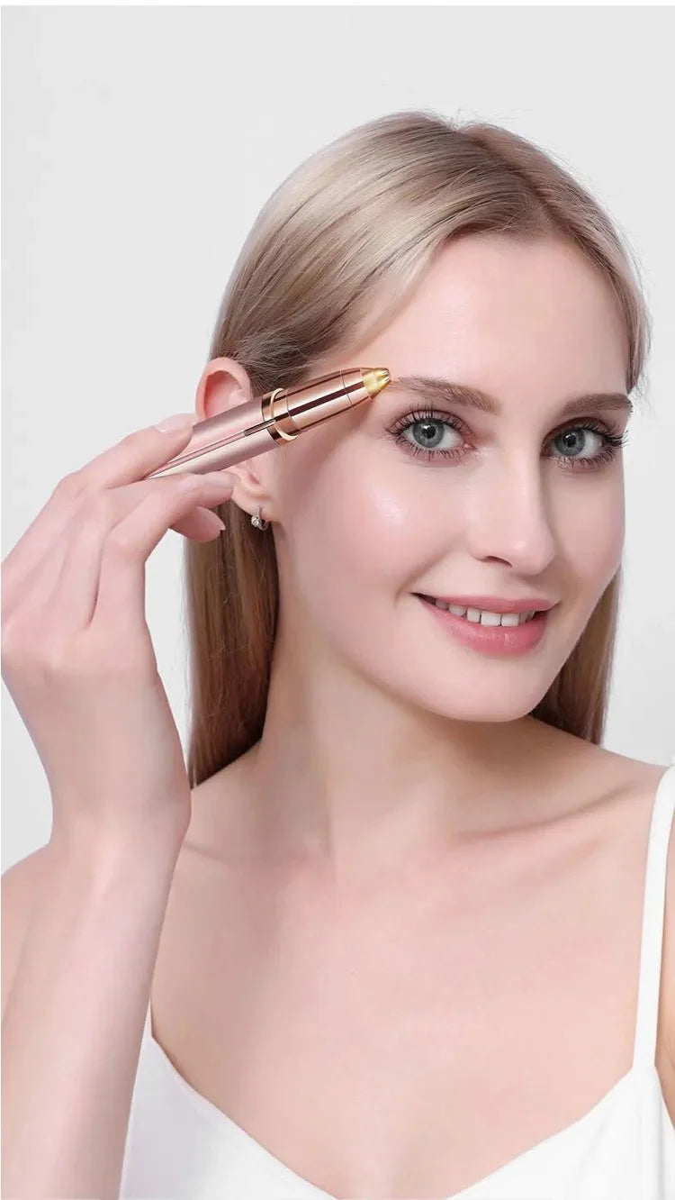 A woman is using a gold-toned electric eyebrow trimmer on her upper eyelid.