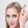 A woman is using a precision electric eyebrow trimmer to trim and tighten her eyebrows.