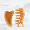 A set of multi-function facial massage and lifting tools in a translucent orange color.