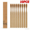 A set of ten disposable bamboo toothbrushes packaged in a cardboard box.