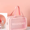A pink transparent cosmetic storage bag with pink straps is displayed against a light pink background.