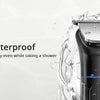 A black electric hair trimmer is shown being used in a shower, emphasizing its waterproof feature.