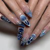 A set of pink flower almond press on nails featuring a gradient blue and white design.