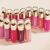 A collection of liquid bronzer contour foundation sticks in various shades of pink and coral.
