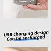 A hand is rinsing a silver electric shaver under running water.