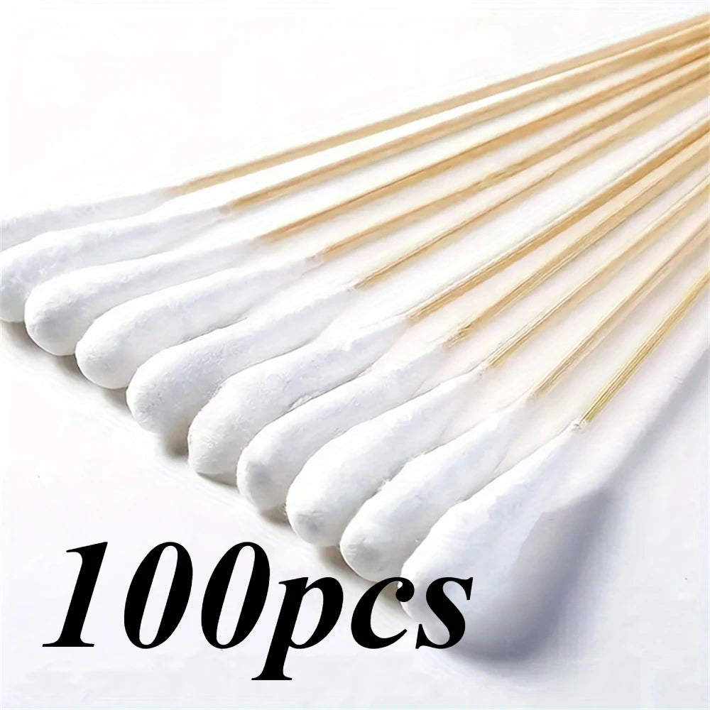 A collection of 100 precision wooden cotton swabs with white tips arranged diagonally.