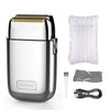 A silver and black professional rechargeable electric hair clipper with a protective cover and charging cable.