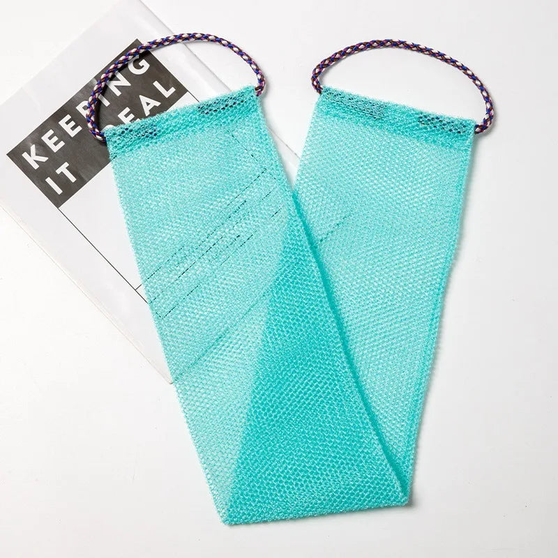 A teal exfoliating sponge with purple string attached, shown next to a product box.