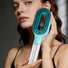 A woman holds a teal hair styling comb and moisturizer spray for hair care.