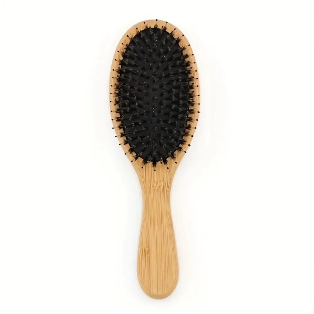 A natural boar bristle hair brush with a light wood bamboo handle.