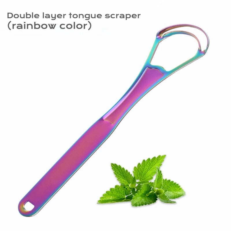 A double layer tongue scraper in a rainbow color next to a sprig of mint leaves.