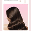 A close-up of long, dark brown hair being curled by a professional automatic rotating ceramic hair curler.