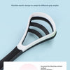 A black and white silicone tongue scraper is shown with a soft curved brush head for oral hygiene.