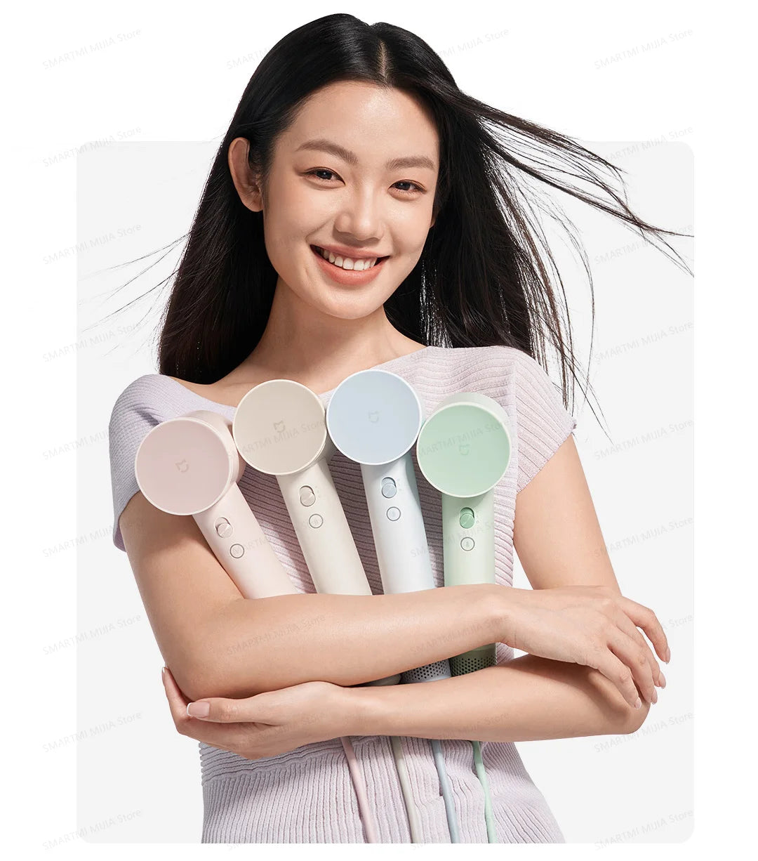 A woman holds a professional high-speed hair dryer with temperature control, featuring multiple colored nozzles.
