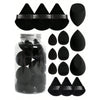 A collection of fifteen black makeup sponges and applicators stored in a clear glass jar.