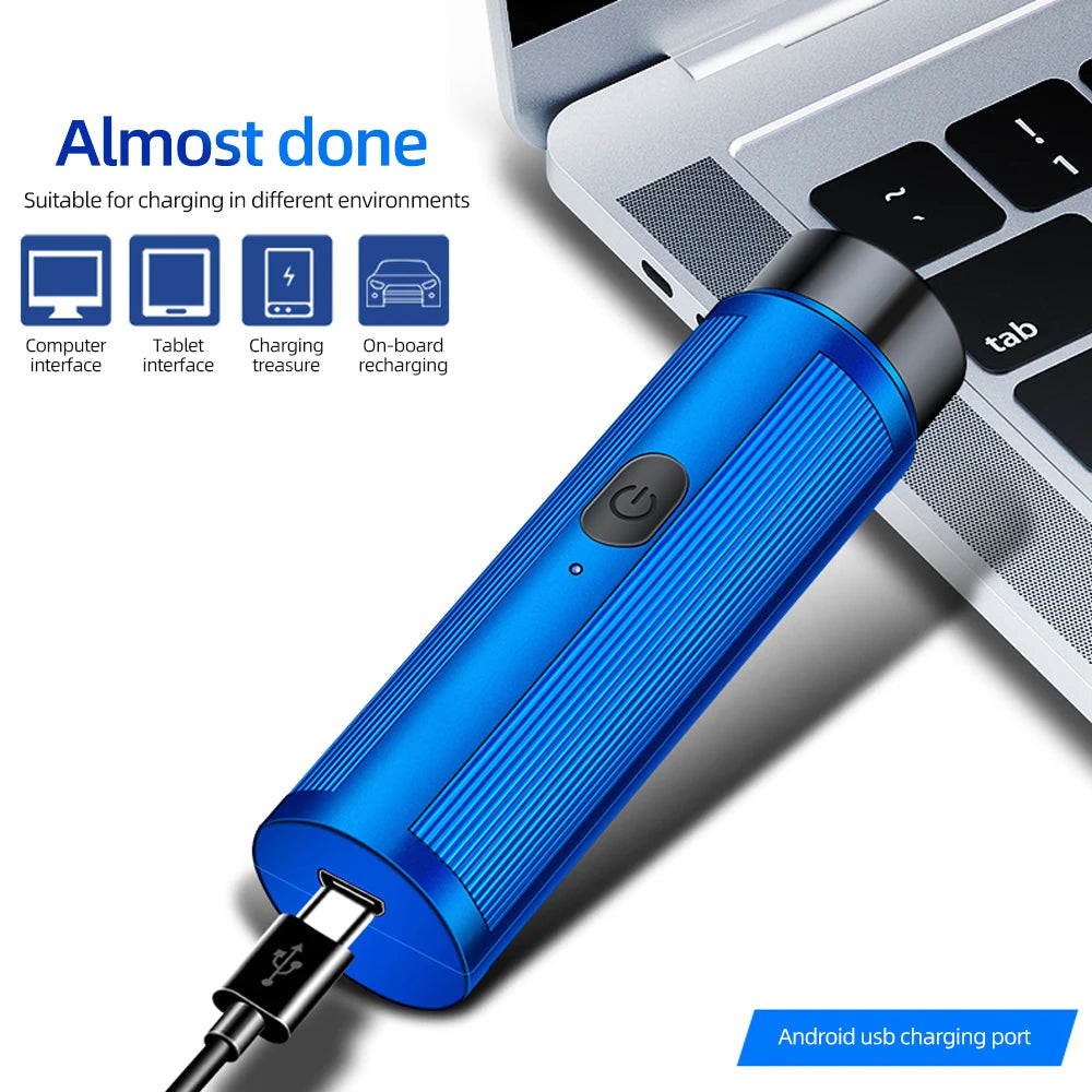 A blue portable electric shaver with an Android USB charging port is shown next to a laptop.