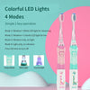 A pink and green electric toothbrush with LED light features four modes including vibration and light options.