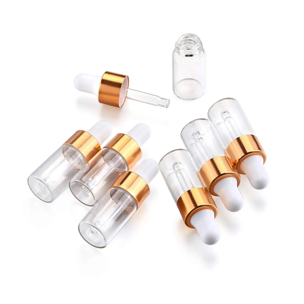 A set of ten glass dropper bottles with gold caps and white droppers for essential oils and samples.