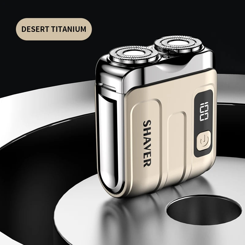 A close-up of a Desert Titanium electric shaver in a beige and silver finish resting on a dark surface.