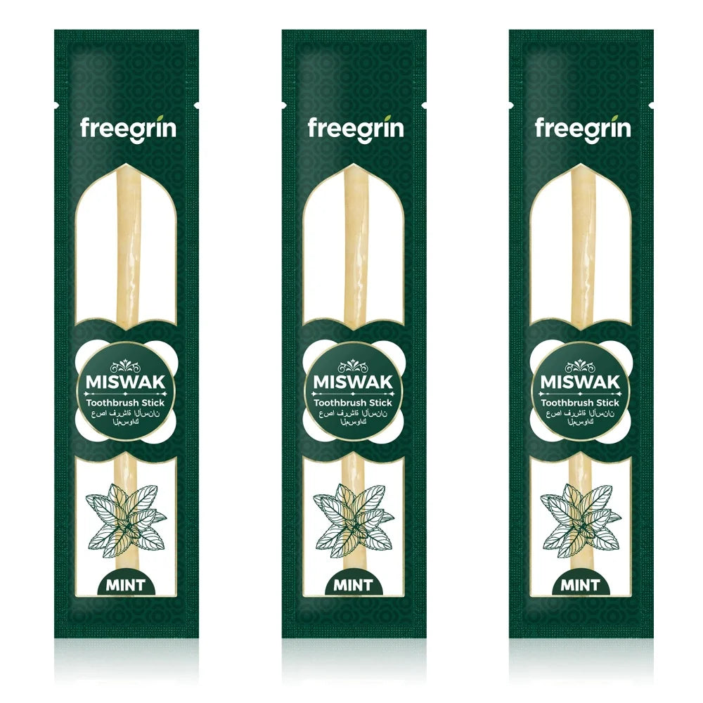 Three packages of freegrin Miswak toothbrush sticks in green packaging with natural wood sticks.