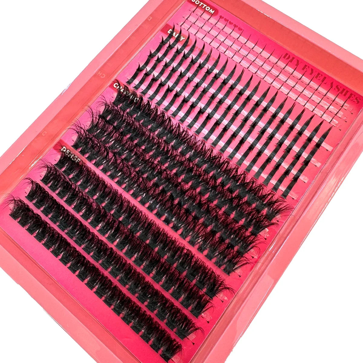 A pink tray of manga lash clusters with bottom and spikes for DIY eyelash extensions.