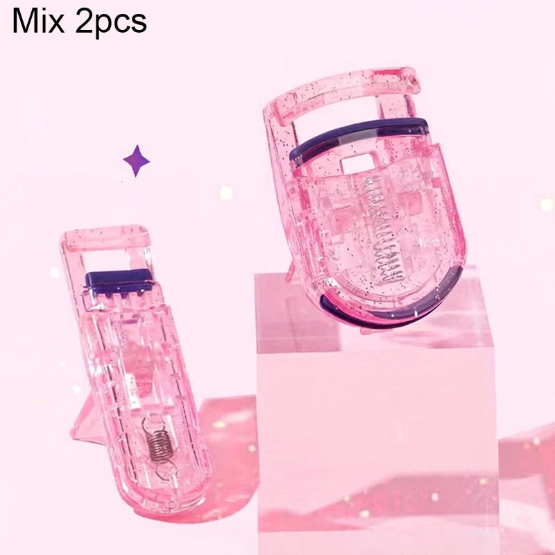 A pink portable mini eyelash curler set displayed on a clear stand.