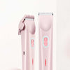 A pink double-headed electric shaver is shown standing upright against a white background.